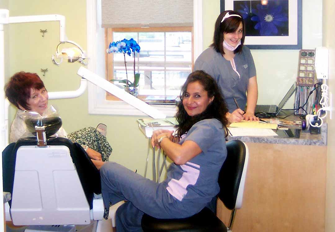 Dental hygienist and patient at All About Smiles
